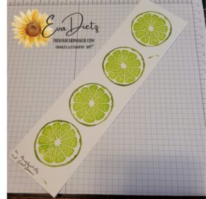 white cardstock strip with 4 stamped lime slices on it