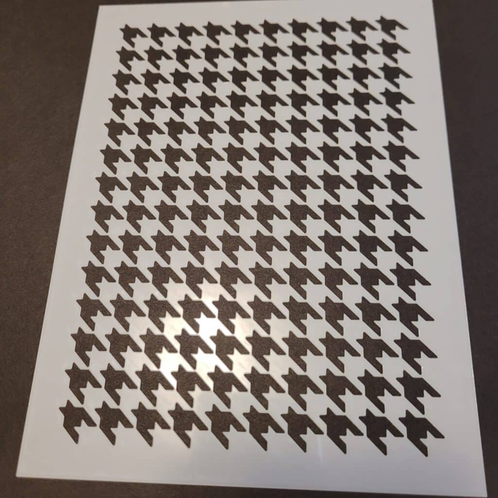 Shows the Houndstooth stencil from Stampin' Up!s Adbundant Beauty Decorative Maks used for placing a pattern on a piece of cardstock with ink and a blending brush
