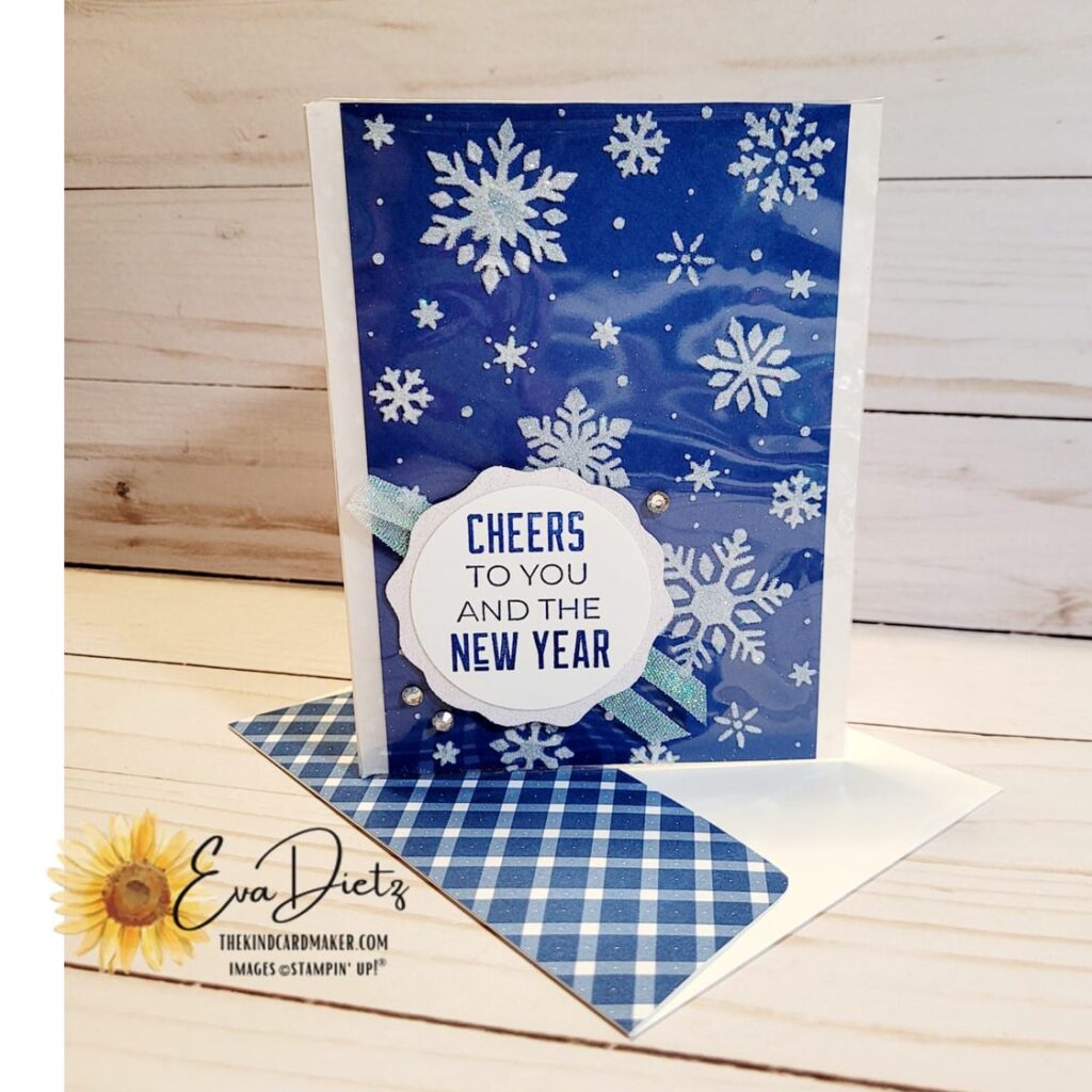 Finished Embossing Paste Snowflake card encapsulated in a clear envelope sitting on top of a matching envelope all in the blueberry bushel color