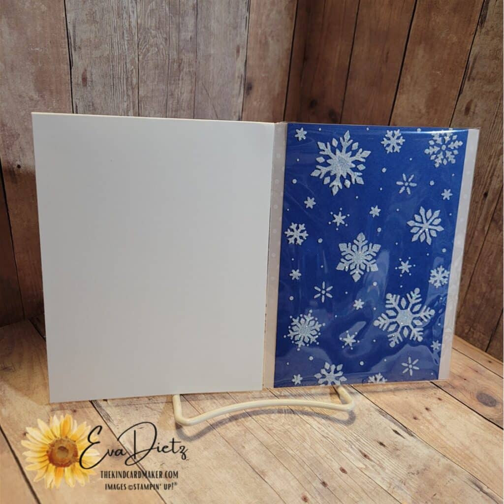 Showing front of embossing paste snowflake card that is enclosed in a clear envelope and the edge is sandwiched between a folded piece of Basic White Cardstock.
