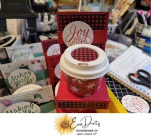 Mini 4 ounce coffee cup filled with hard candy set in the holder where you can put a gift card behind the cup.