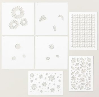Photo shows the set of 7 plastic stencils that are part of Stampin' Up!s Abundant Beauty Decorative Masks. The set includes a houndstooth pattern, fall leaves, snowflakes, and a 4 step sunflower design.