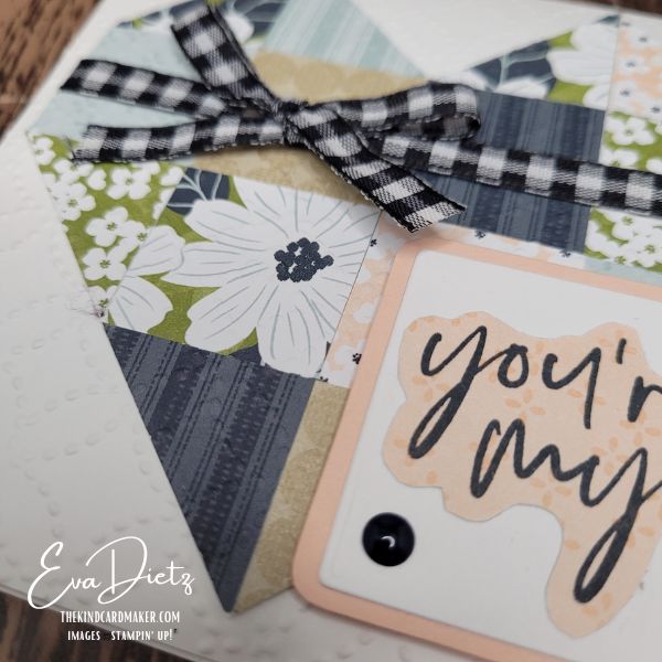 Close up view of card front using layered arch-shaped sentiment tag demonstrating how to create wider borders without additional dies